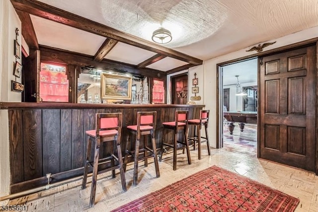 bar featuring beam ceiling