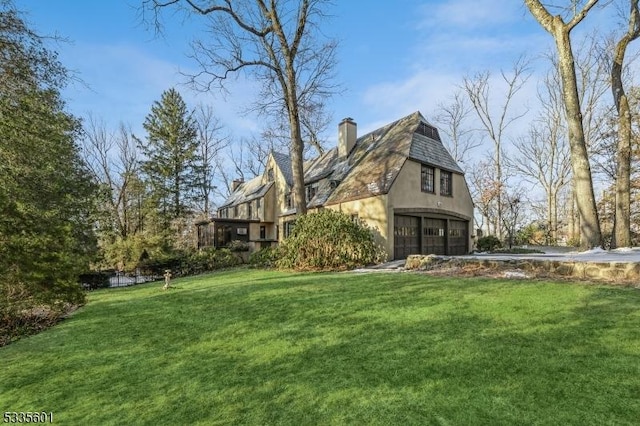 view of home's exterior with a yard and a garage