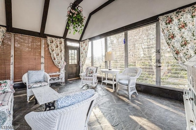 sunroom / solarium featuring lofted ceiling with beams