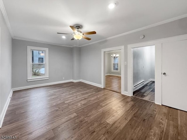 unfurnished bedroom featuring ceiling fan with notable chandelier, ensuite bathroom, dark hardwood / wood-style flooring, baseboard heating, and ornamental molding