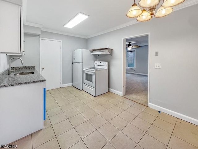 kitchen featuring white appliances, dark stone counters, white cabinets, crown molding, and sink