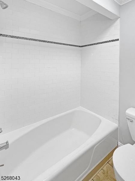 bathroom featuring tiled shower / bath, crown molding, toilet, and hardwood / wood-style floors