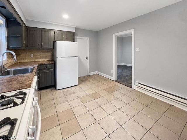 kitchen with tasteful backsplash, a baseboard radiator, white appliances, light tile patterned floors, and sink