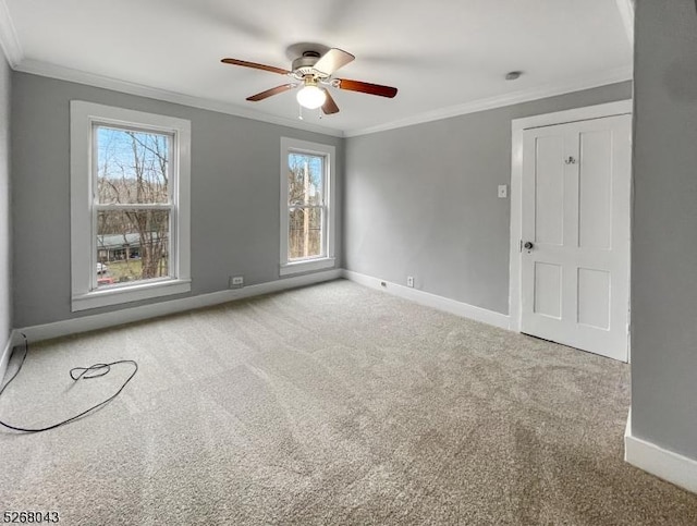 carpeted empty room featuring ceiling fan and ornamental molding