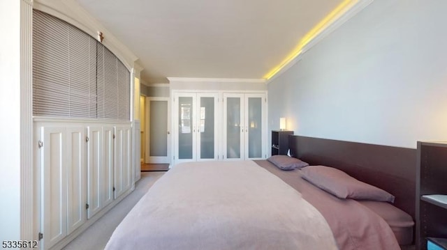 carpeted bedroom featuring ornamental molding