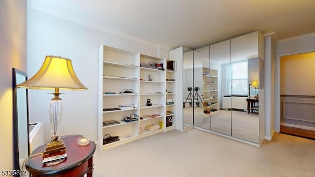 interior space featuring crown molding and light carpet