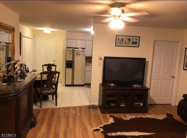 living room featuring light hardwood / wood-style flooring and ceiling fan