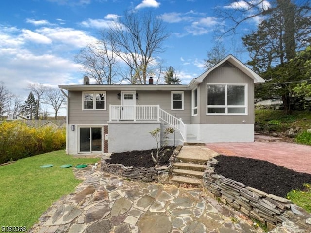 rear view of house with a patio area and a lawn