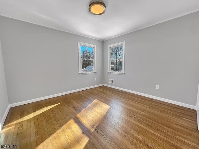 unfurnished room featuring hardwood / wood-style floors