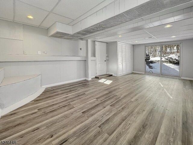 interior space featuring hardwood / wood-style floors and a drop ceiling