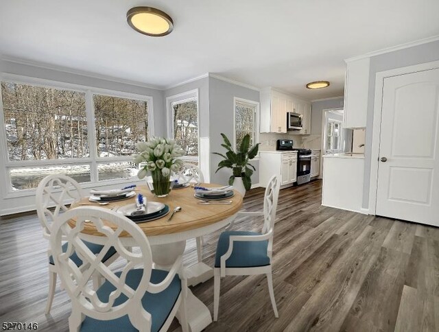 dining room featuring dark wood-type flooring and ornamental molding