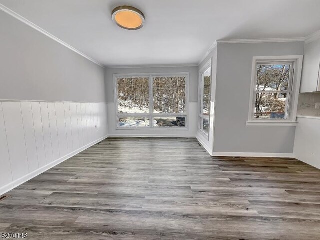 interior space featuring ornamental molding and dark wood-type flooring