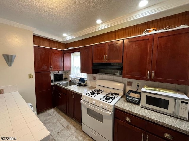 kitchen with sink, white appliances, tasteful backsplash, extractor fan, and a textured ceiling