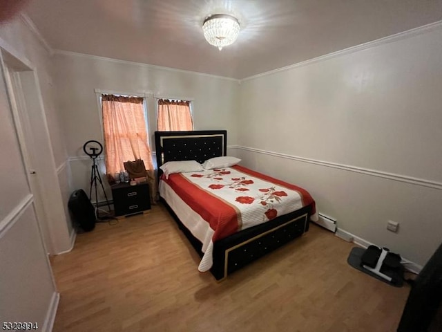 bedroom with wood-type flooring and ornamental molding