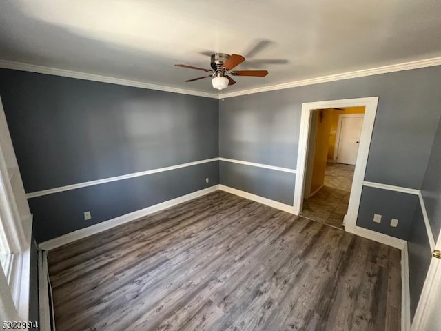 spare room with crown molding, dark hardwood / wood-style flooring, and ceiling fan