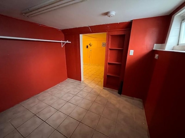 walk in closet with tile patterned floors