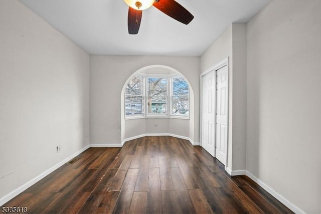 spare room featuring dark hardwood / wood-style floors and ceiling fan