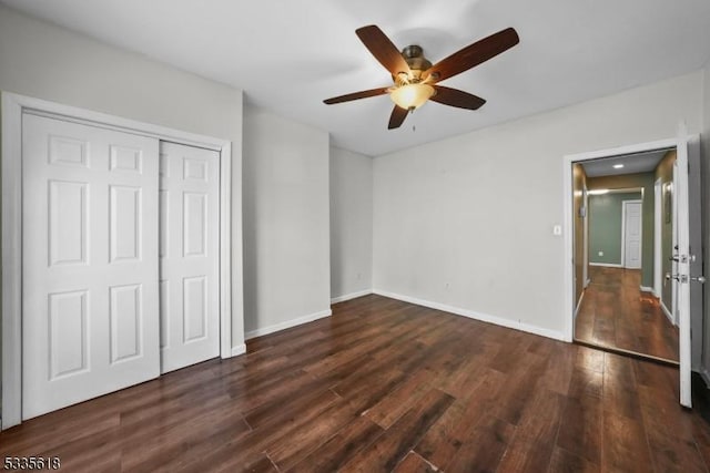 unfurnished bedroom with ceiling fan, dark hardwood / wood-style floors, and a closet