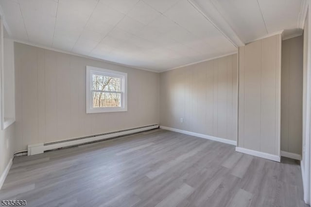 empty room with crown molding, a baseboard radiator, and light hardwood / wood-style floors