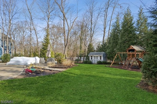 view of yard featuring a storage shed and a playground