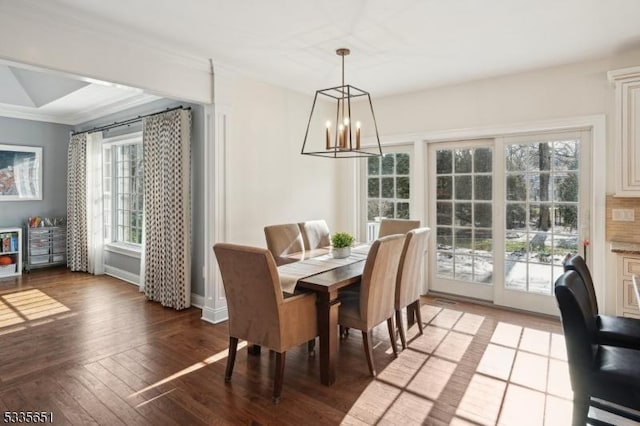 dining room with ornamental molding, a chandelier, and hardwood / wood-style floors