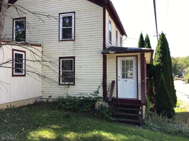 back of house with a lawn