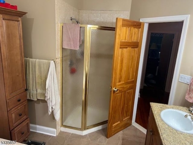 bathroom featuring an enclosed shower and vanity