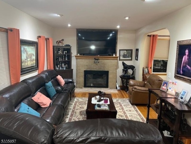 living room featuring hardwood / wood-style floors and a brick fireplace