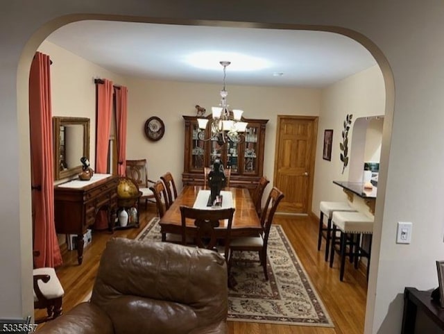 dining area with an inviting chandelier and hardwood / wood-style floors