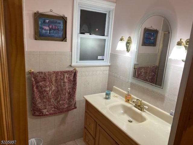 bathroom with vanity and tile walls