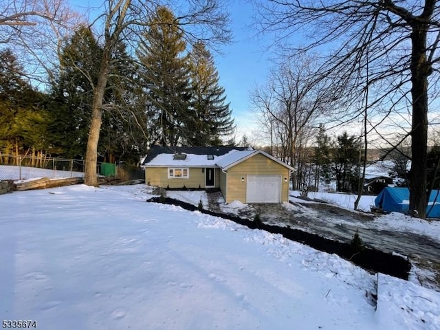 view of front of home with a garage and fence