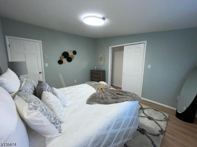 bedroom with wood finished floors and baseboards