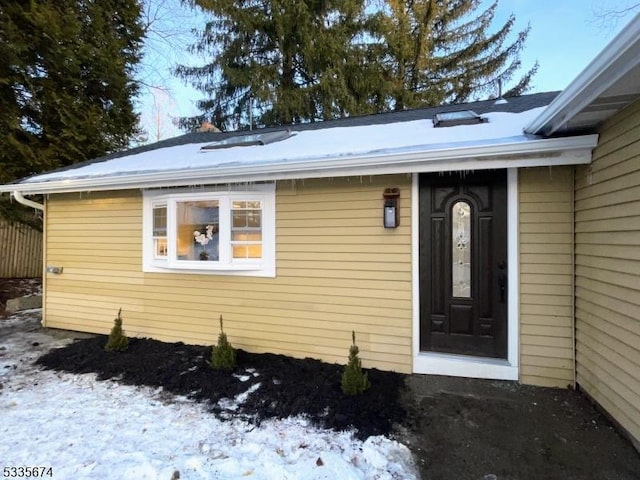 view of snow covered property entrance