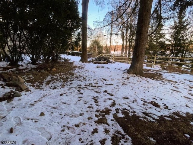 yard layered in snow with fence