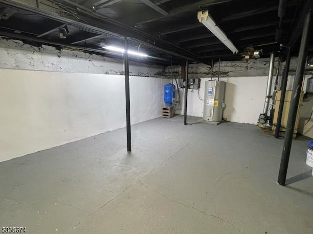 unfinished basement featuring water heater