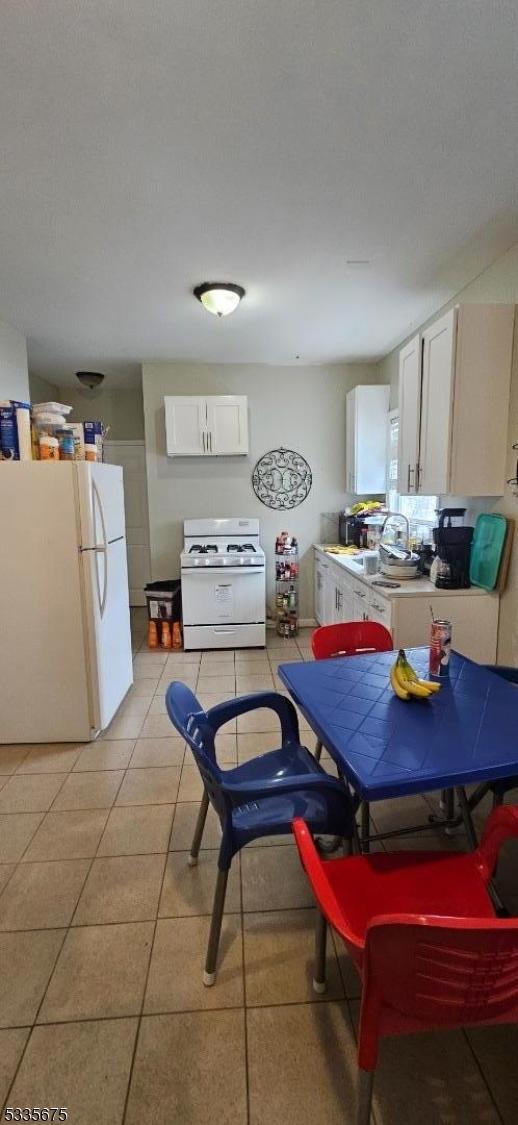 dining room with light tile patterned flooring and sink