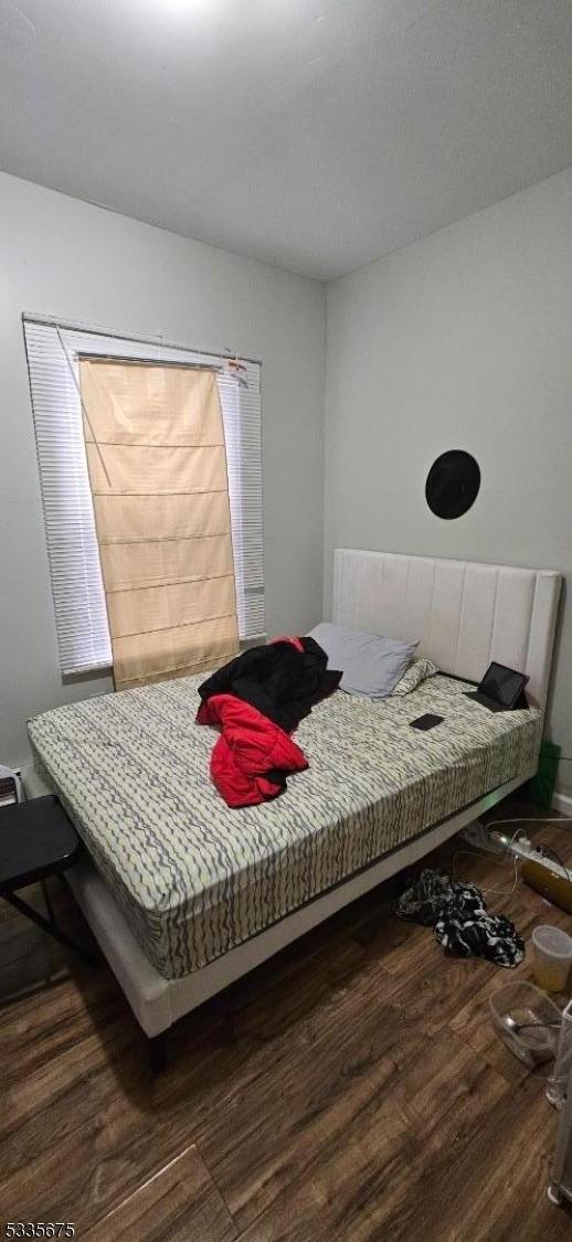 bedroom featuring dark hardwood / wood-style flooring