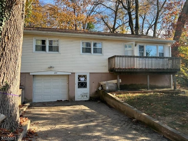 view of front of house featuring a garage and a wooden deck