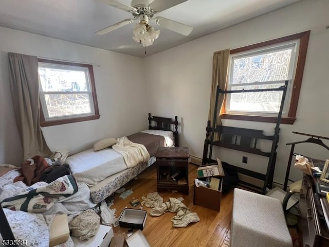 bedroom with hardwood / wood-style floors and ceiling fan