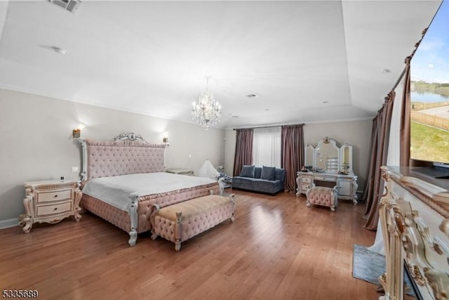 bedroom with ornamental molding, dark hardwood / wood-style floors, and an inviting chandelier