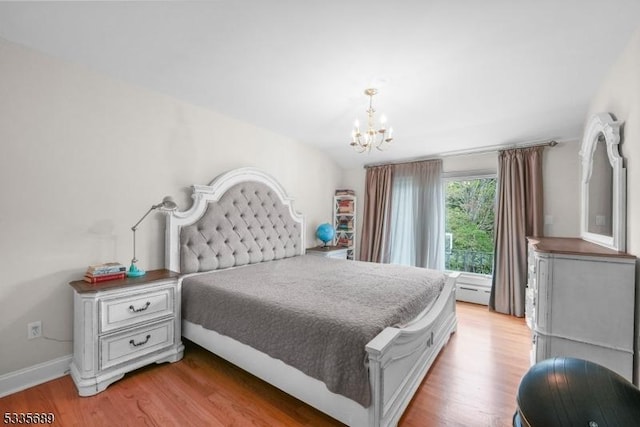 bedroom featuring light hardwood / wood-style flooring and a chandelier