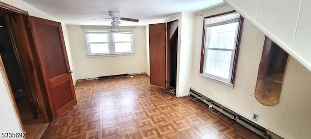 interior space with parquet flooring and ceiling fan