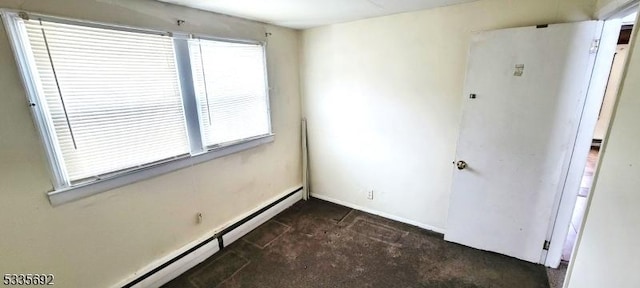 spare room with baseboard heating and a wealth of natural light