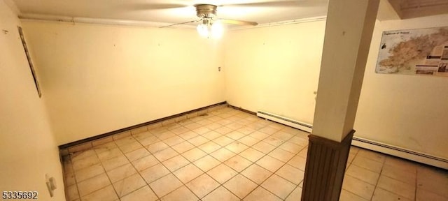 tiled spare room with a baseboard heating unit and ceiling fan