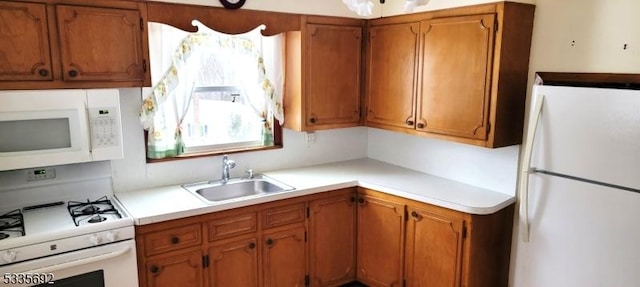 kitchen with sink and white appliances