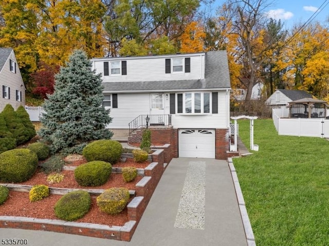 view of front of home with a garage and a front yard