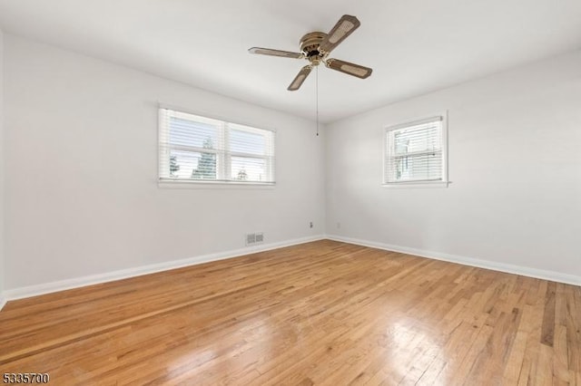 spare room featuring ceiling fan and light hardwood / wood-style flooring