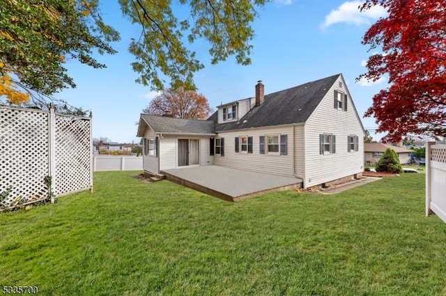 back of house with a yard and a patio area