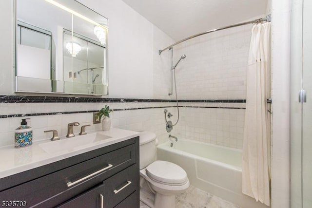 full bathroom featuring vanity, toilet, tile walls, and shower / bath combo