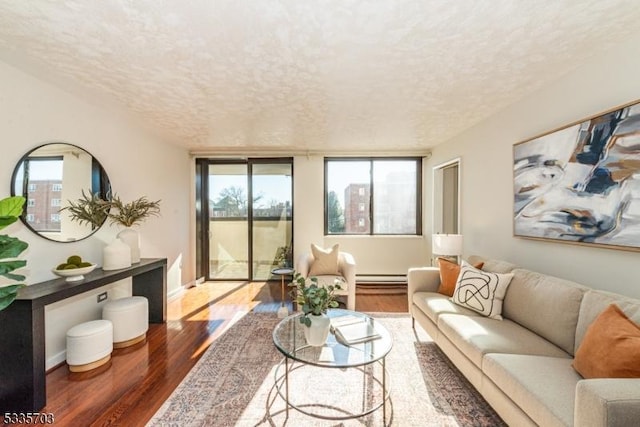 living room with dark hardwood / wood-style flooring, a baseboard radiator, and a textured ceiling